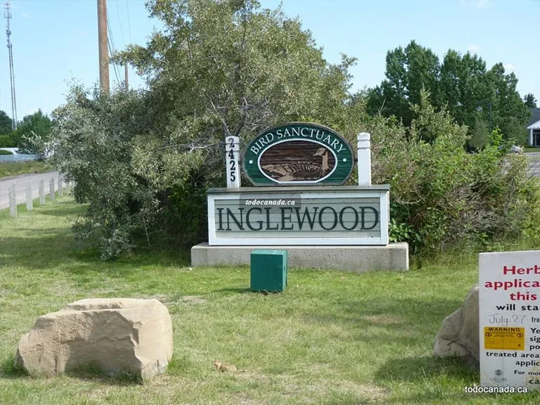 The Inglewood Bird Sanctuary entrance sign surrounded by shrubs and grass